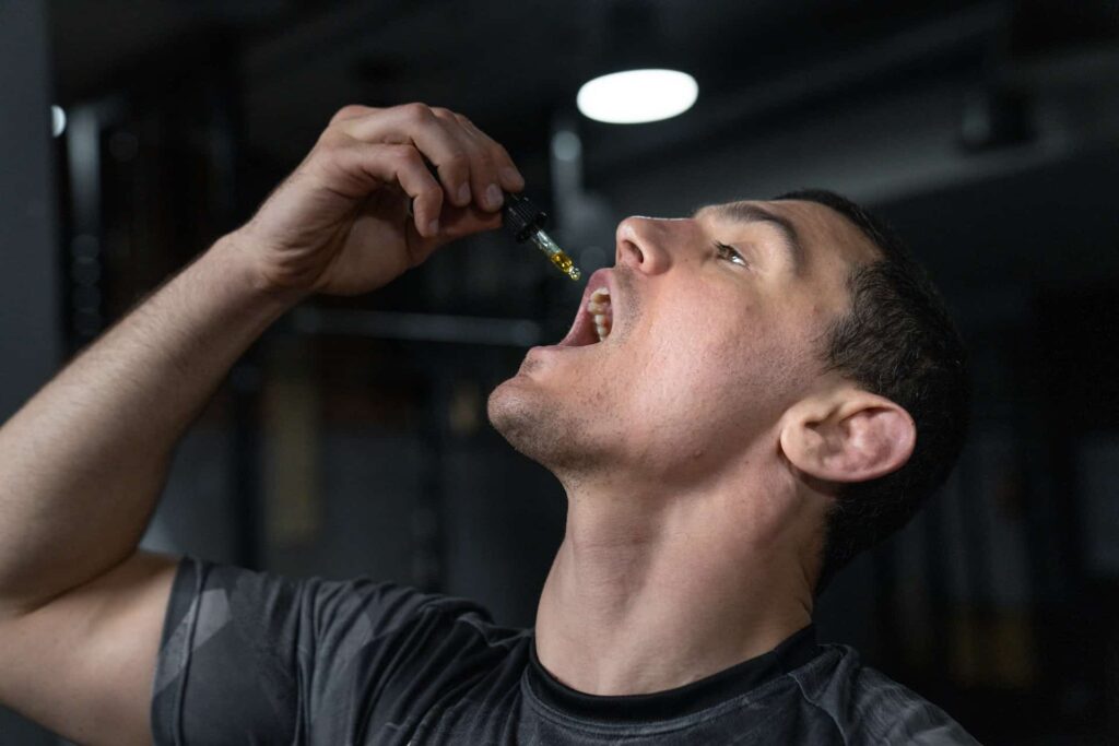 Man taking CBD oil by mouth