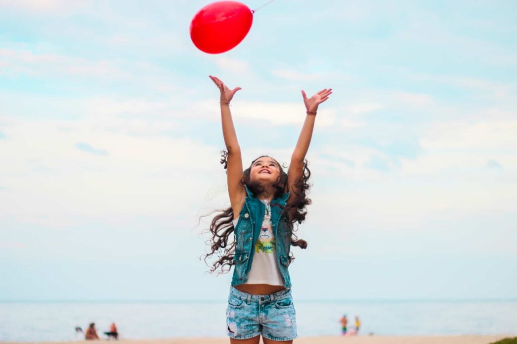 Child jumping towards a balloon